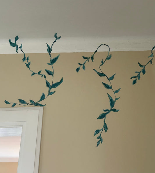 Slingrande gröna växter på vardagsrumsvägg.